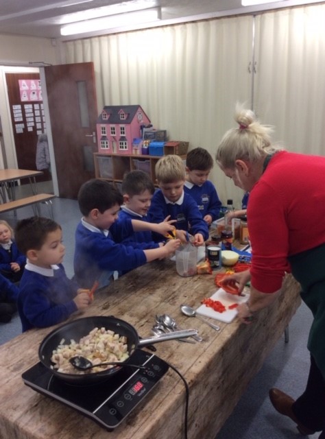 Reception children making curry